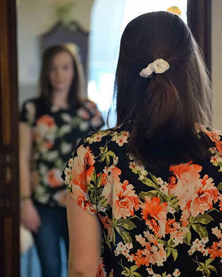 Frau im geblümten Kleid von hinten – Mädchensprechstunde in der Praxis Özdogan in Hagen